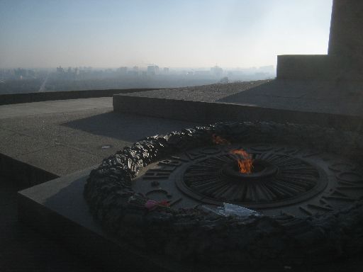Eternal flame with the buildings on the east side of the Dnieper River in the background