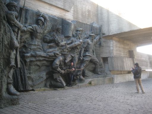 Someone posing with another sculpture